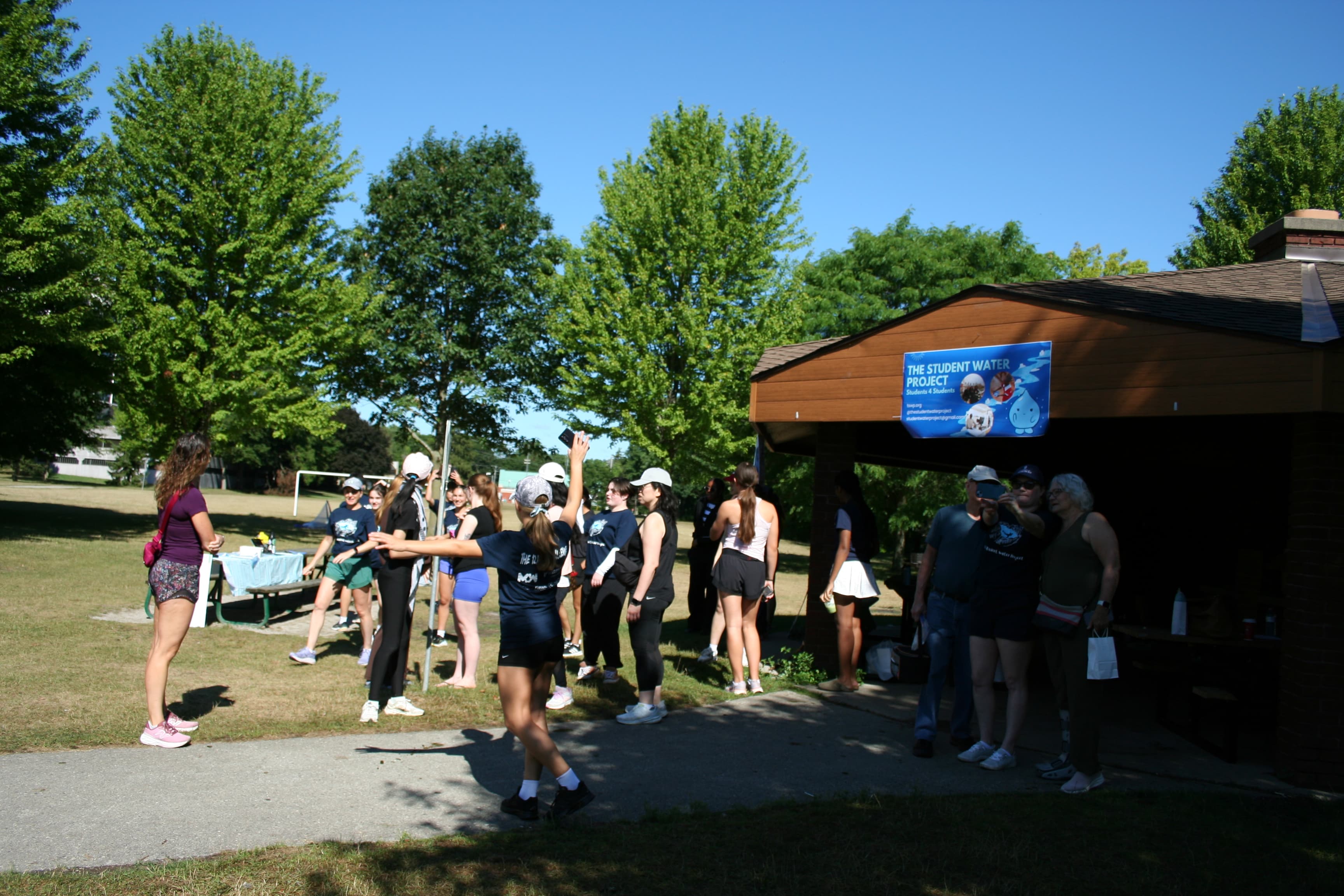 A crowd of volunteers gathered outside The Student Water Project's event pavilion
