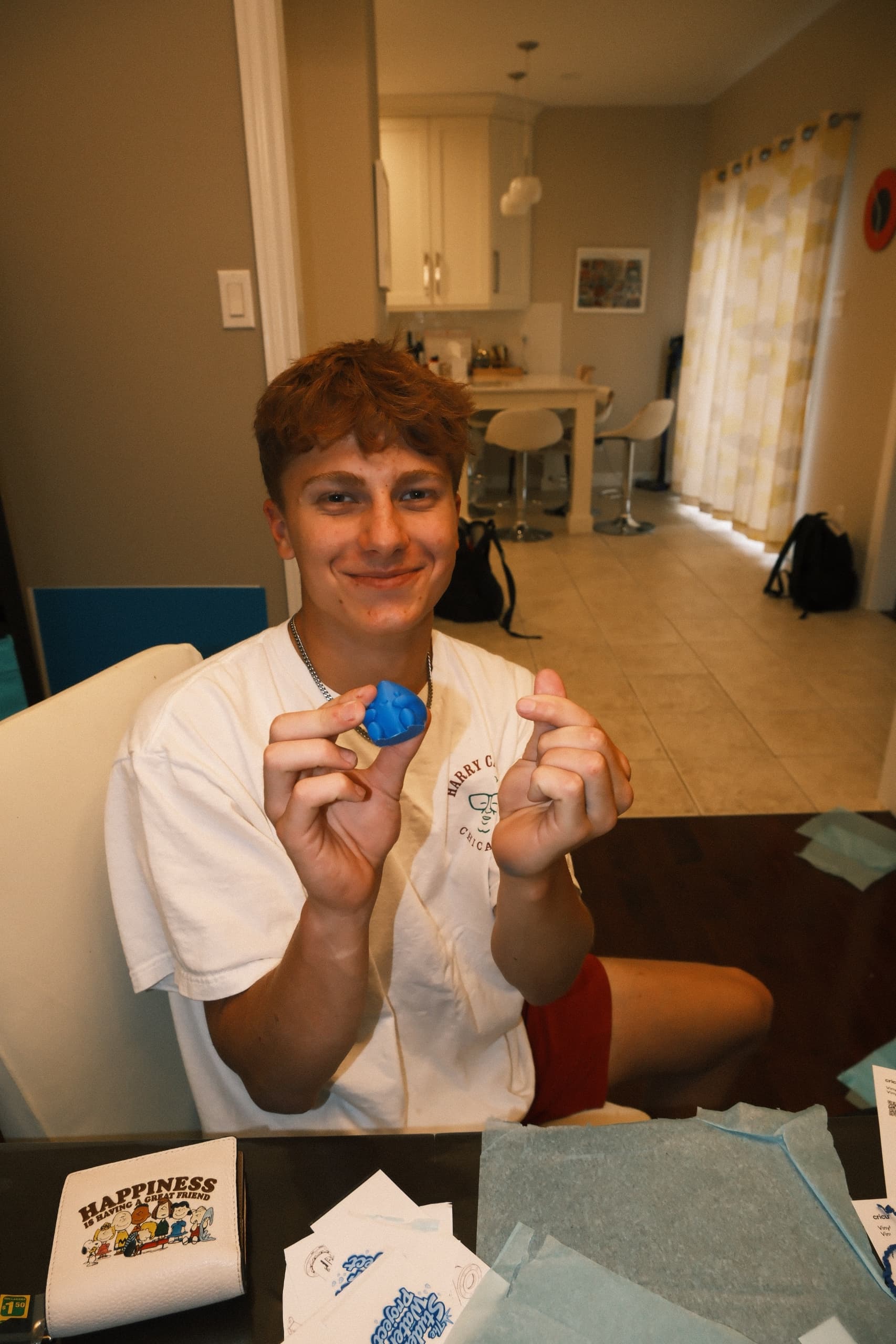 A student volunteer holding a handmade TSWP keychain