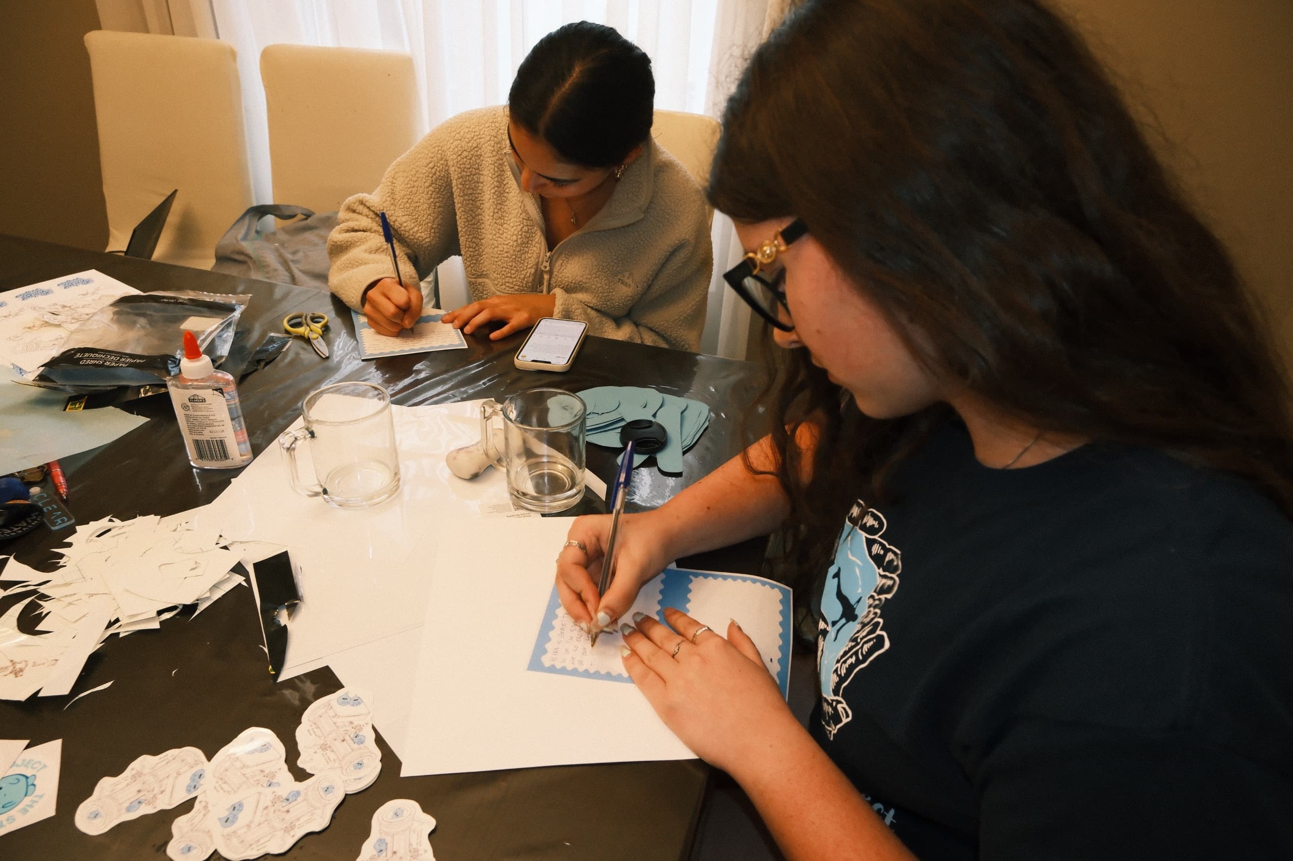 Volunteers crafting thank-you cards and stickers for TSWP supporters